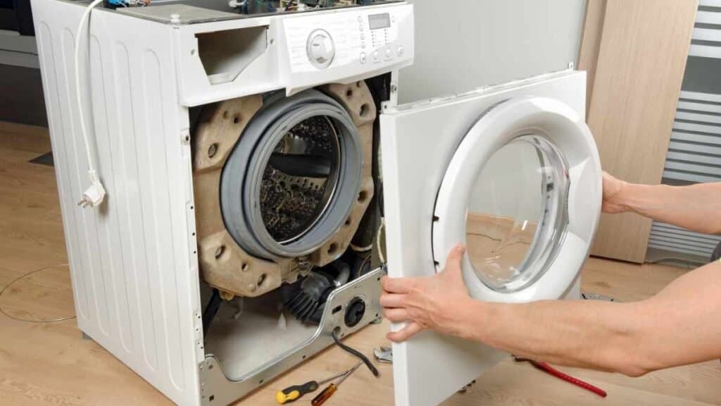 Washer Repair Vancouver! Technician opening front-loading washing machine during repair service in Vancouver