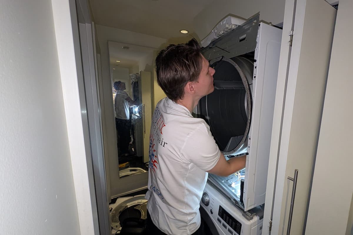 EasyFix Appliance Repair technician repairing a dryer in Vancouver apartment laundry closet