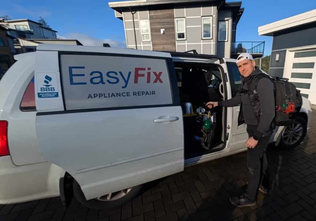 EasyFix Appliance Repair technician in Langley standing next to branded service van