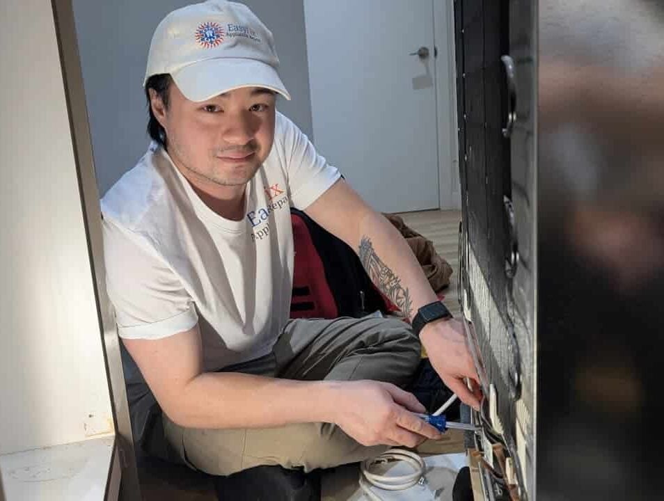 Appliance repair technician servicing a household appliance in White Rock BC