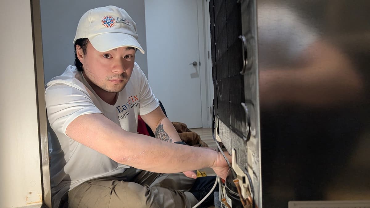 EasyFix Appliance Repair technician repairing a refrigerator in a Pitt Meadows home