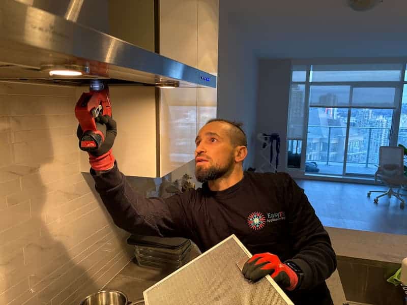 EasyFix technician installing a hood fan in a Vancouver kitchen