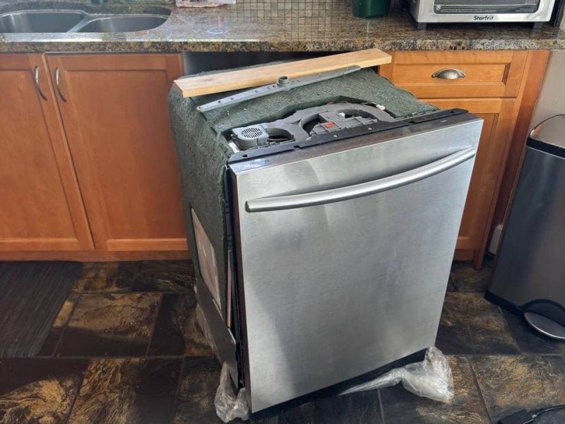 Appliance Installation Vancouver installing new dishwasher in kitchen